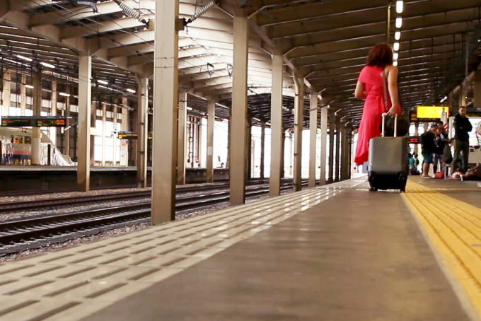 woman with suitcase in japan train station