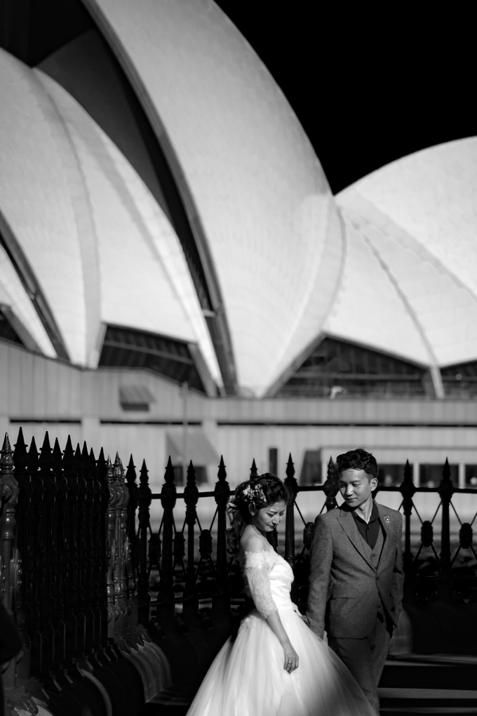 Asian wedding couple taking pictures at Sydney Opera House, Australia