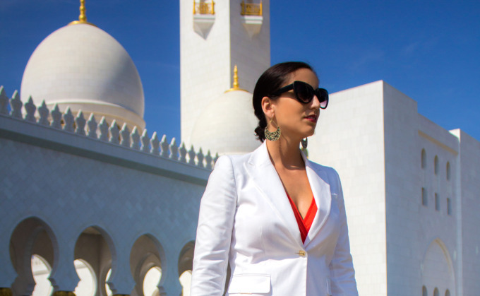 Jessica Peterson, girl in white jacket, standing outside Grand Mosque in Abu Dhabi, United Arab Emirates