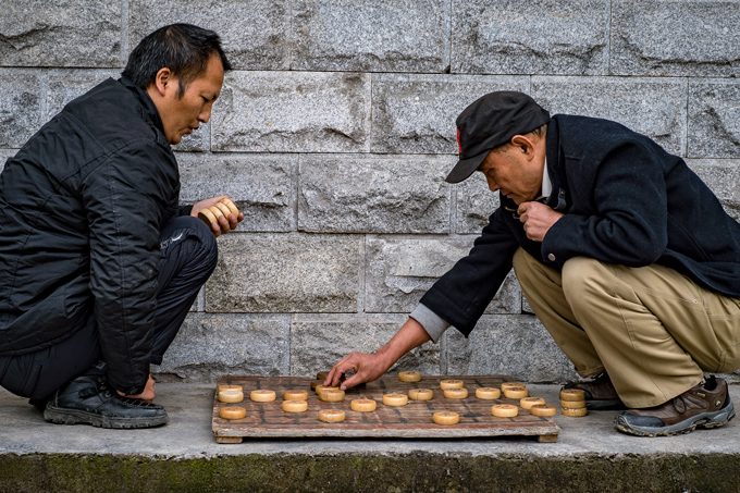 Men playing game on street in Zhangjiajie, China