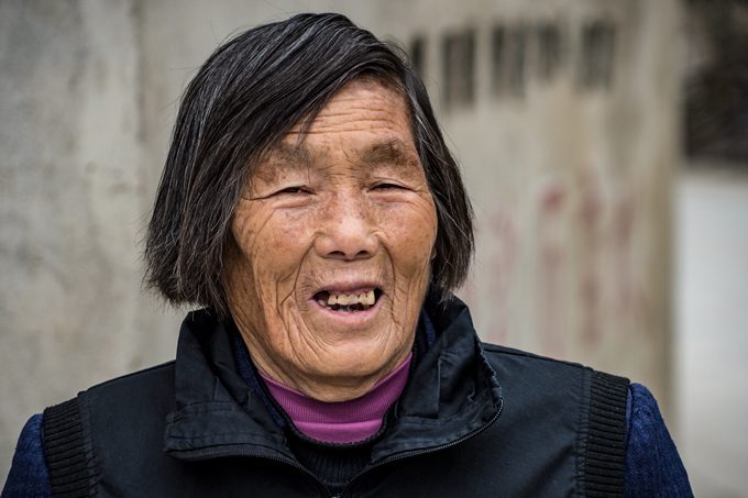 Old woman smiling in Zhangjiajie, China