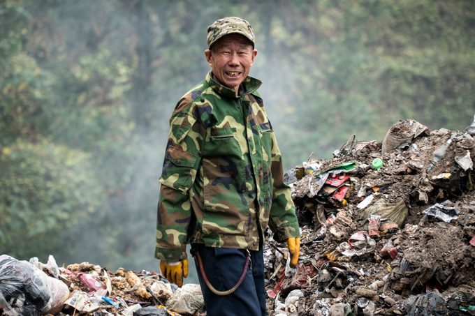 Man sifting trash in Zhangjiajie, China
