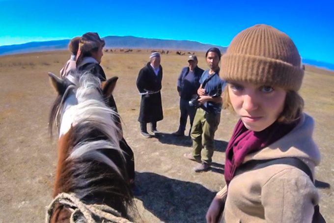 Ansley Sawyer with horse in Mongolia looking at camera