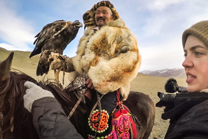 Ansley Sawyer directing, Mongolian man on a horse with a hawk in a traditional fur coat