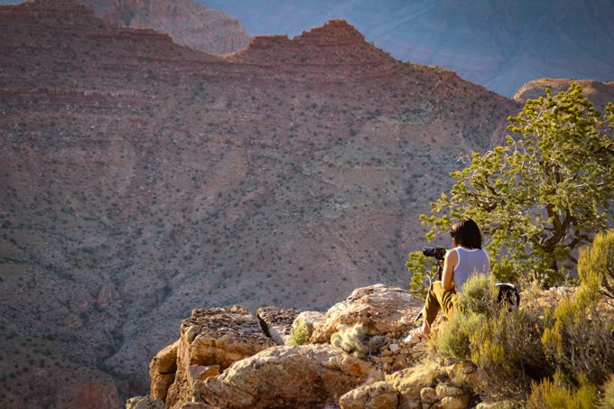 Jessica Peterson of Global Girl Travels taking photographs at Grand Canyon, Arizona