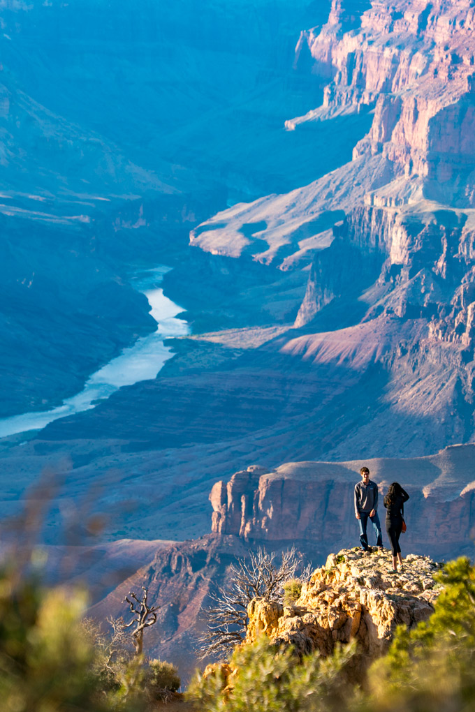 Two hikers pose for a photograph at the Watchtower at Grand Canyon, Arizona