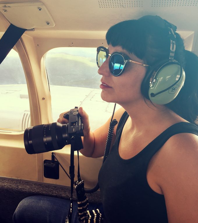 Jessica Peterson of Global Girl Travels on a plane in Alaska with Sony camera