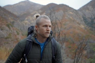 Man hiking in mountains wearing WantDo jacket