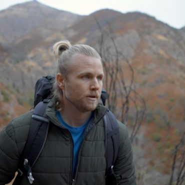 Man hiking in mountains wearing WantDo jacket